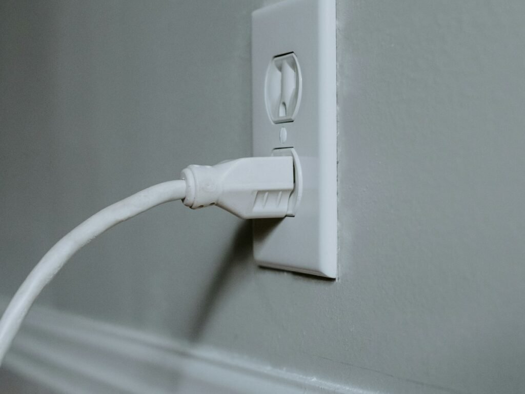 White smart plug in a wall outlet
