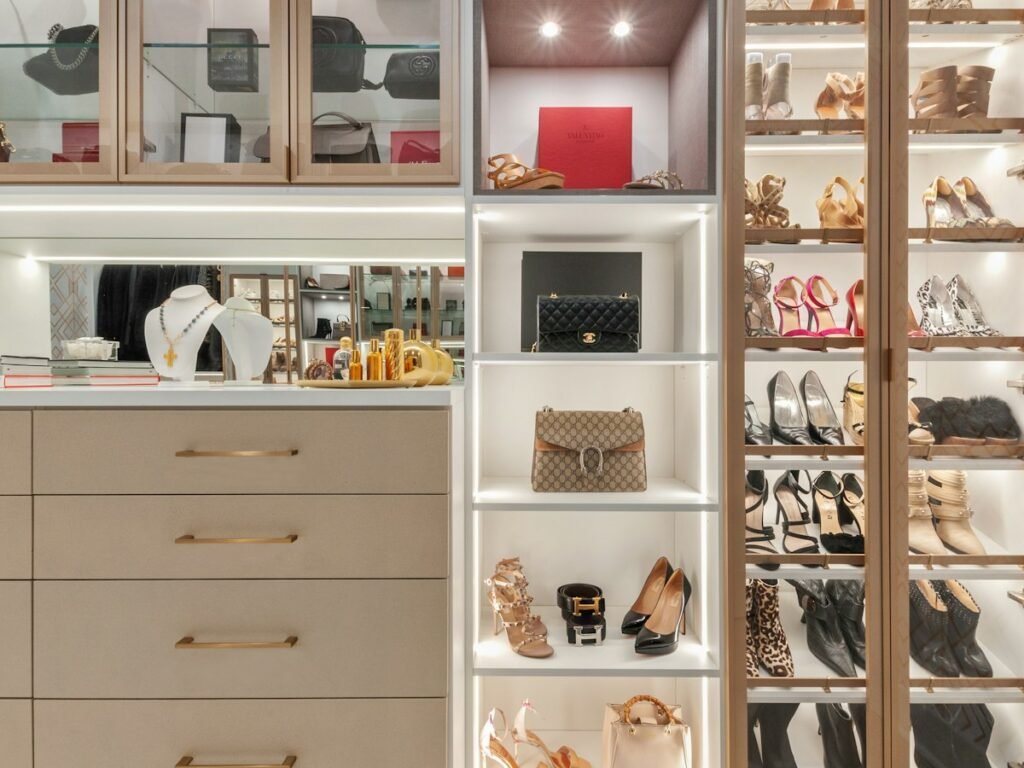 White wooden shelf organizer with folded items